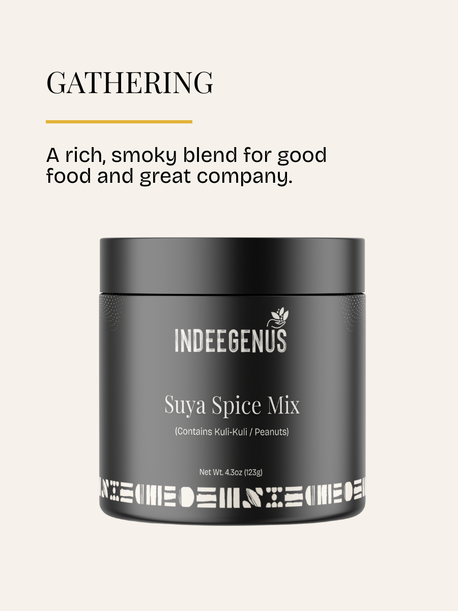 A black jar of INDEGENUS Suya Spice Mix on a light beige background with promotional text above reading 'GATHERING' and 'A rich, smoky blend for good food and great company.'.